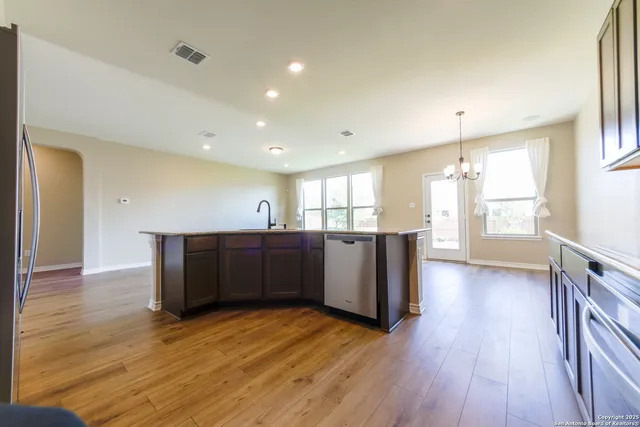 a view of kitchen with cabinets and wooden floor
