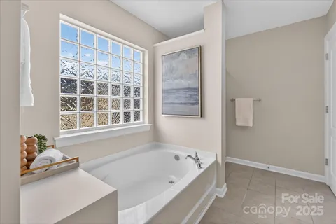 a bathroom with a bathtub and a window