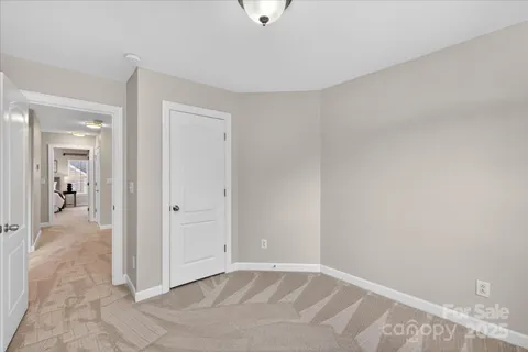 a view of a livingroom with wooden floor and a bathroom