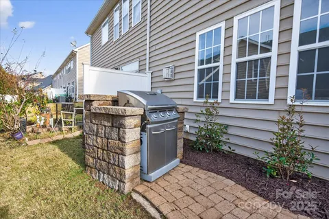 a front view of a house with plants
