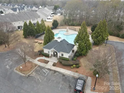 an aerial view of a house with garden space and street view
