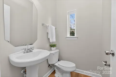 a bathroom with a sink toilet and a mirror