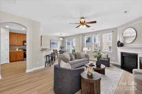 a living room with furniture a fireplace and wooden floor
