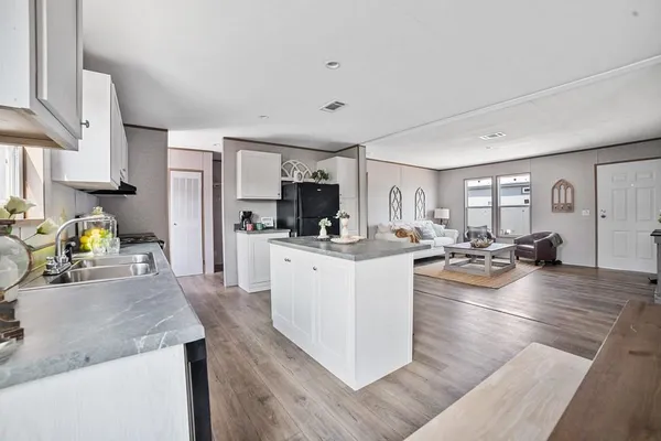a kitchen with sink refrigerator and cabinets