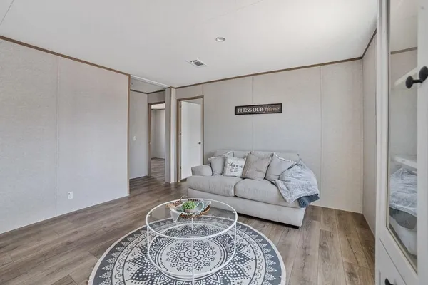 a living room with furniture and a wooden floor