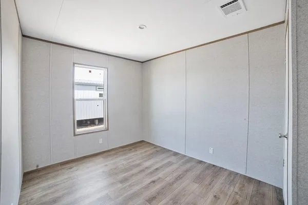 an empty room with windows and closet