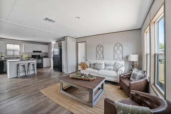 a living room with furniture and wooden floor