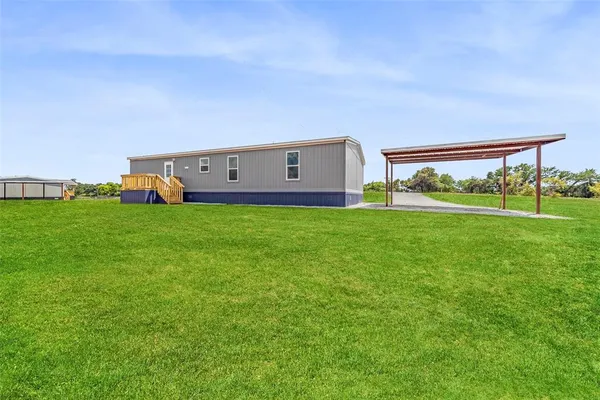 a view of a house with a big yard