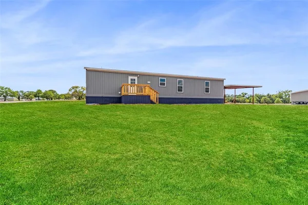 a view of a house with a big yard