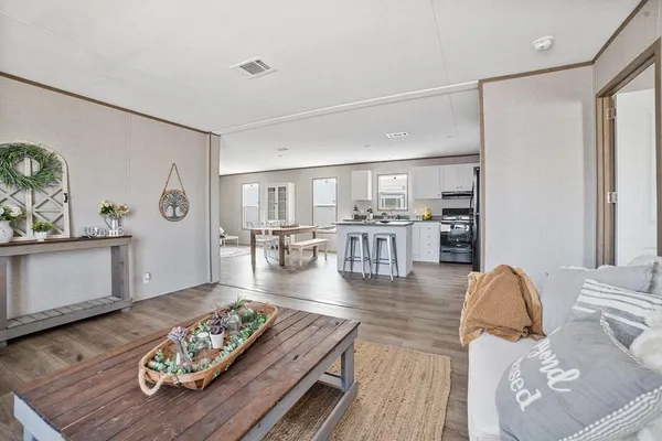 a living room with furniture and wooden floor