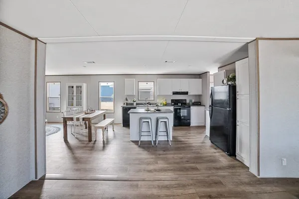 a kitchen with stainless steel appliances granite countertop a refrigerator and a stove top oven