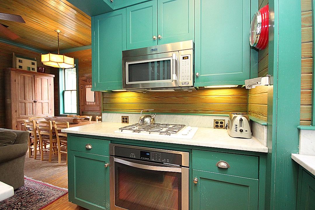 147 Grayton Street Santa Rosa Beach, FL 32459 - Photo 12 of 52 a kitchen with kitchen island a sink stove and microwave