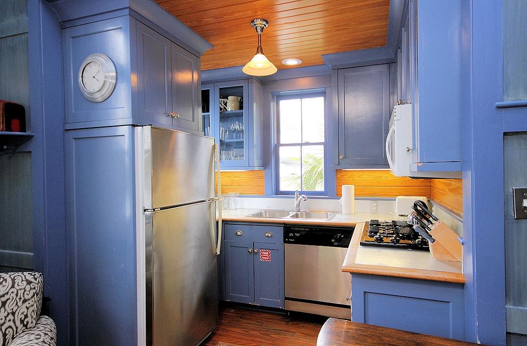 147 Grayton Street Santa Rosa Beach, FL 32459 - Photo 29 of 52 a kitchen with stainless steel appliances granite countertop a refrigerator a stove and a sink with wooden floor