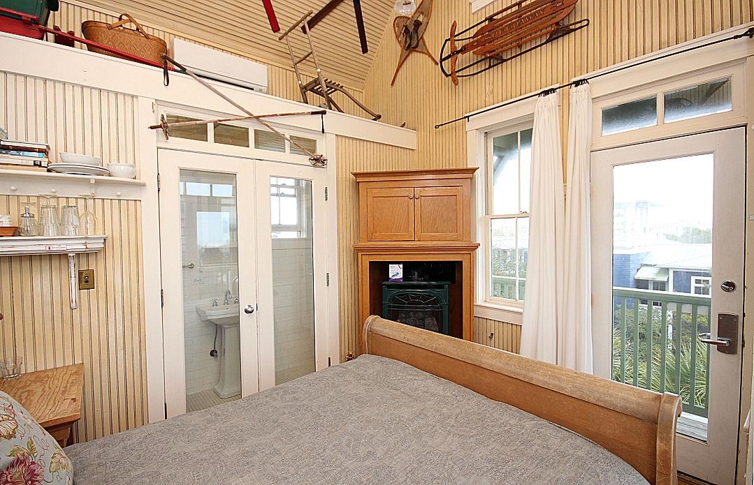 147 Grayton Street Santa Rosa Beach, FL 32459 - Photo 36 of 52 a view of a porch with a floor to ceiling window and wooden fence