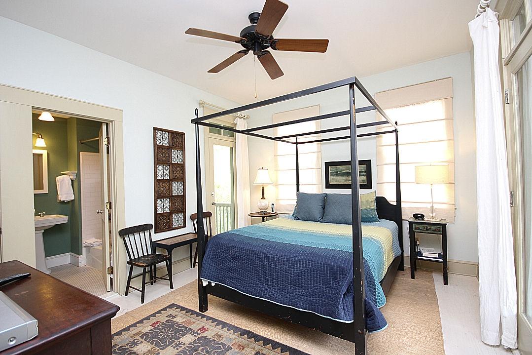 147 Grayton Street Santa Rosa Beach, FL 32459 - Photo 43 of 52 a bedroom with a bed a table and large windows