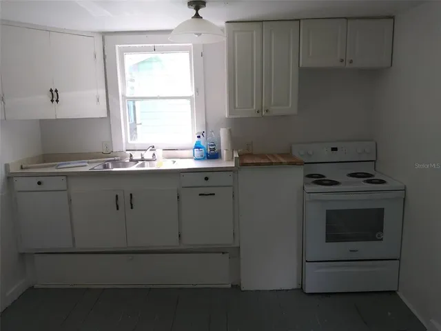 a room with window and cabinet