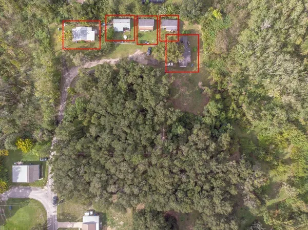 a view of a city with lush green forest