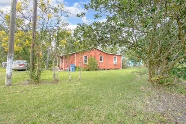 a view of house with swimming pool and sitting area