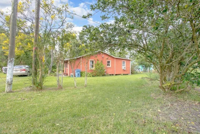 a view of house with swimming pool and sitting area