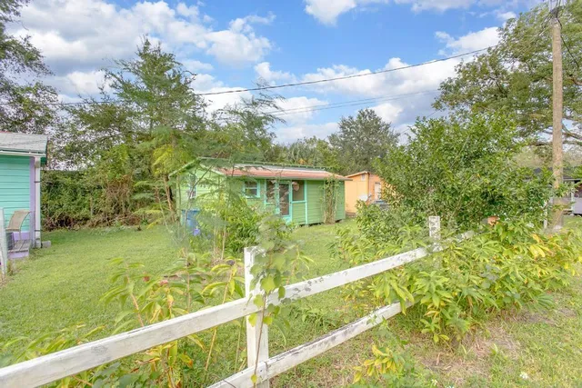 a view of an house with backyard space and garden