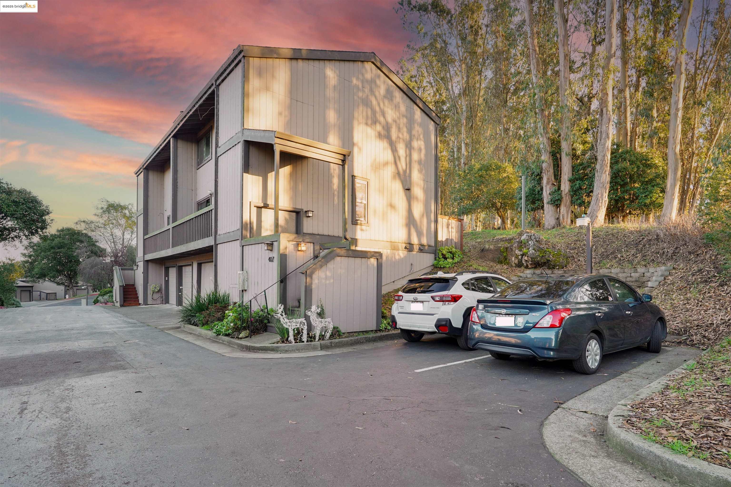 Property at dusk featuring an attached garage