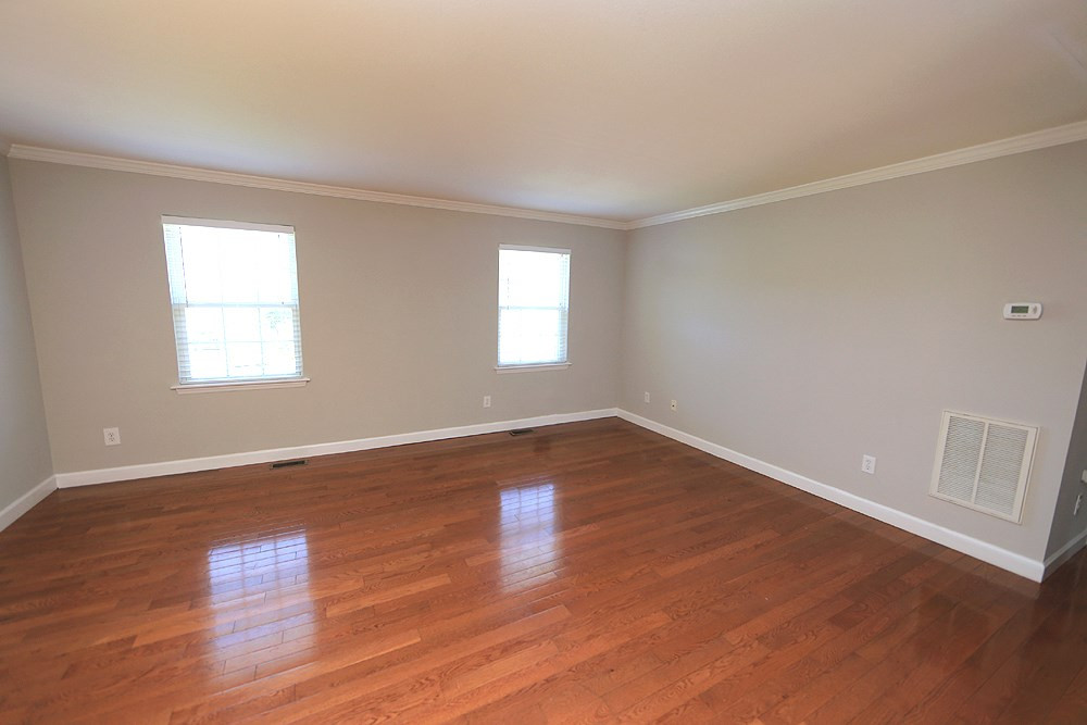 Another view of the living room with hardwood floors and crown molding. Living Room