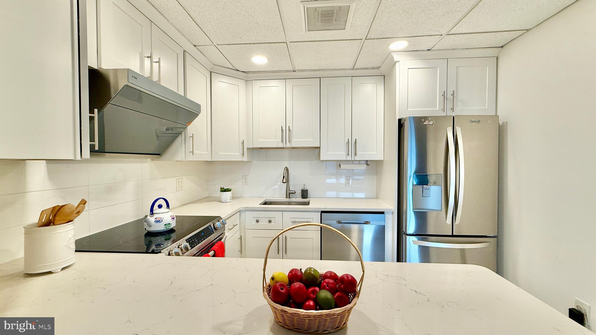 1 Markham Road, Unit 2E Princeton, NJ 08540 - Photo 18 of 30 a kitchen with stainless steel appliances a sink a refrigerator and cabinets