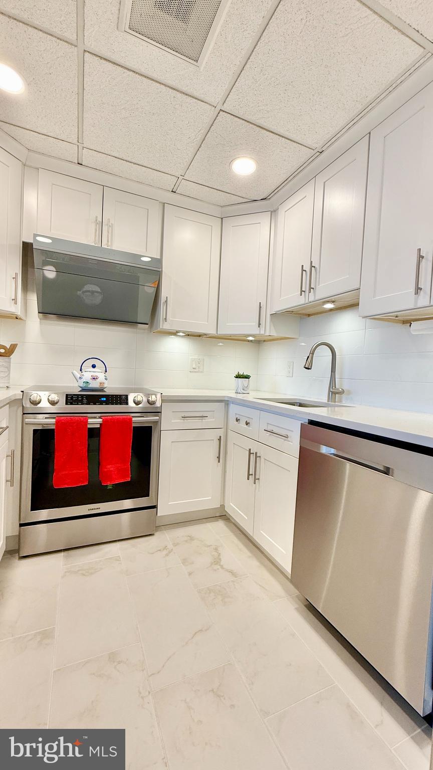 1 Markham Road, Unit 2E Princeton, NJ 08540 - Photo 19 of 30 a kitchen with stainless steel appliances granite countertop a sink and cabinets