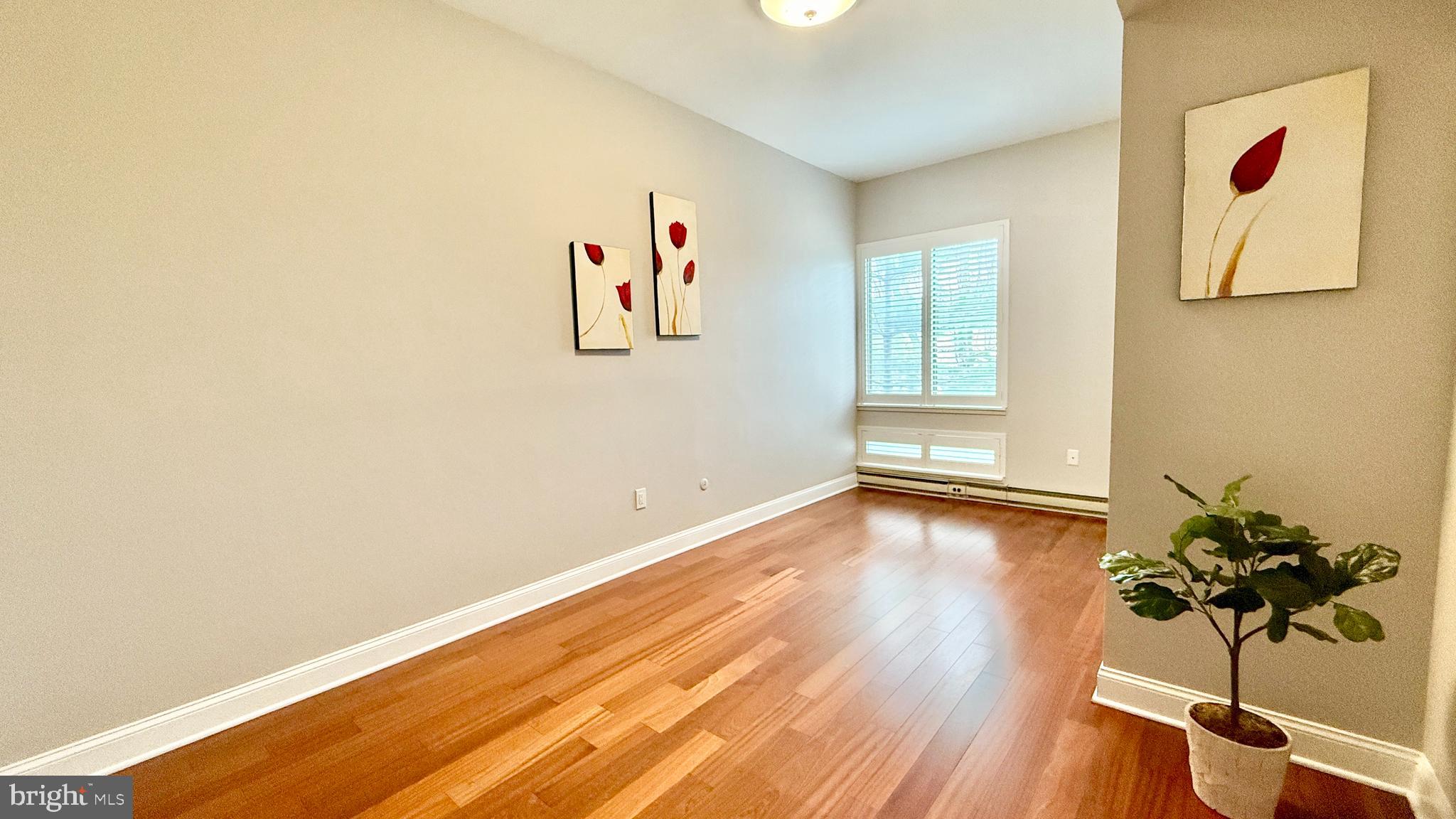 1 Markham Road, Unit 2E Princeton, NJ 08540 - Photo 21 of 30 a view of a room with wooden floor and a potted plant