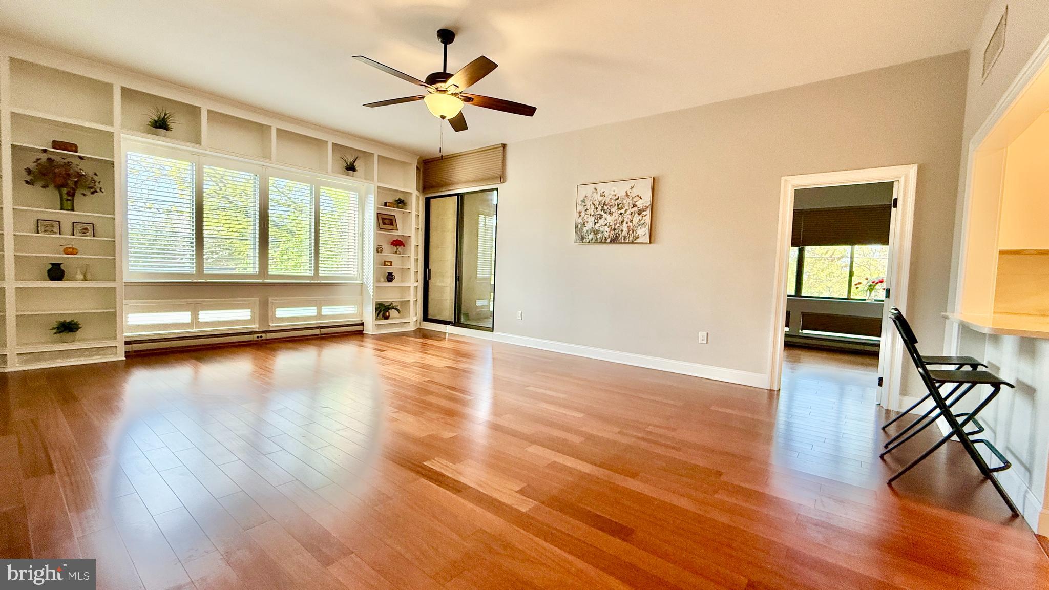 1 Markham Road, Unit 2E Princeton, NJ 08540 - Photo 5 of 30 a view of a livingroom with wooden floor and a ceiling fan