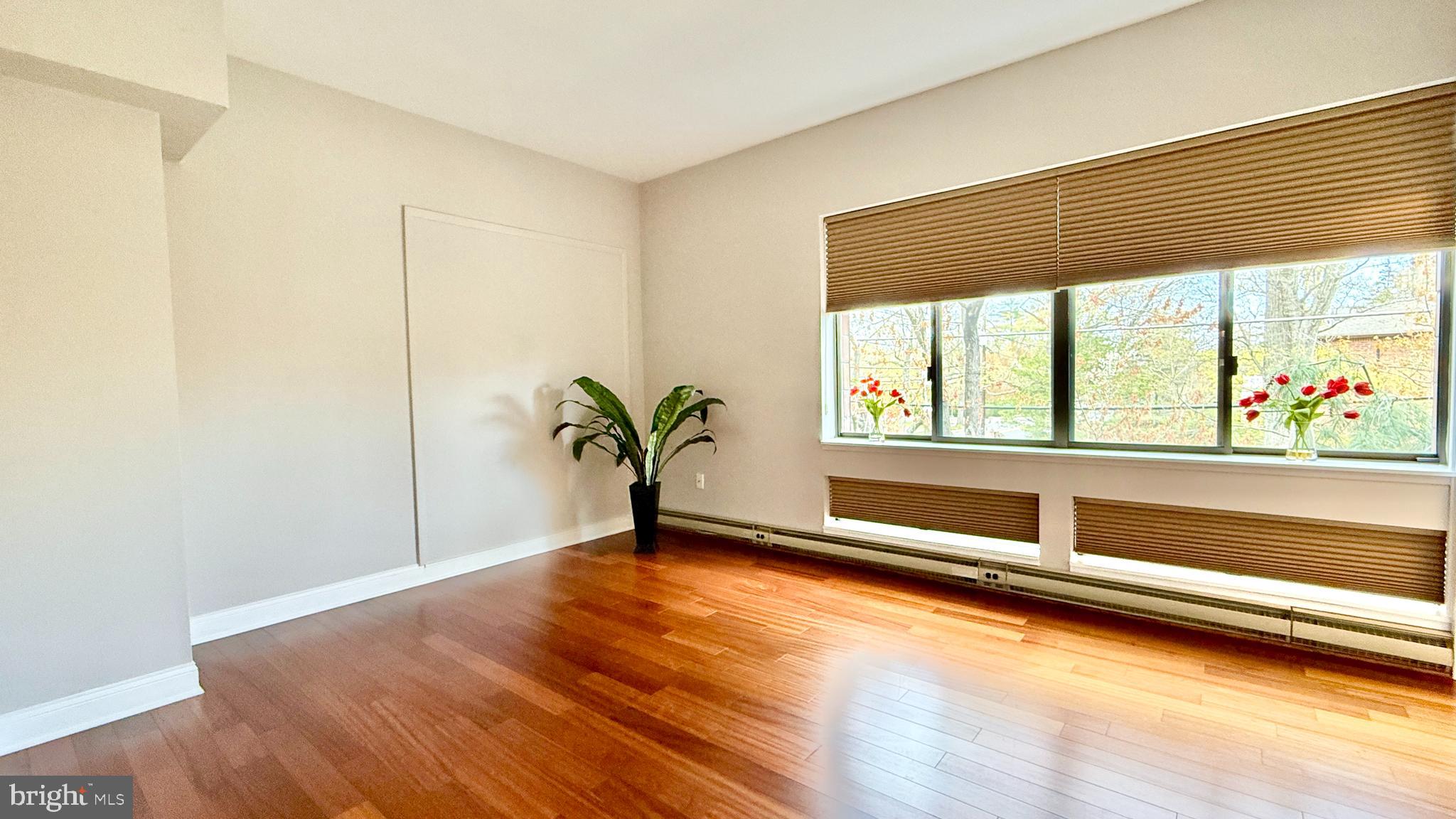 1 Markham Road, Unit 2E Princeton, NJ 08540 - Photo 6 of 30 a view of an empty room with wooden floor and a window