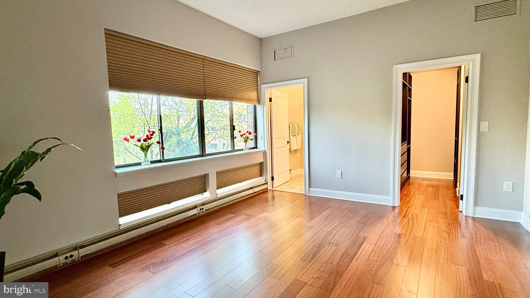 1 Markham Road, Unit 2E Princeton, NJ 08540 - Photo 7 of 30 an empty room with wooden floor and windows