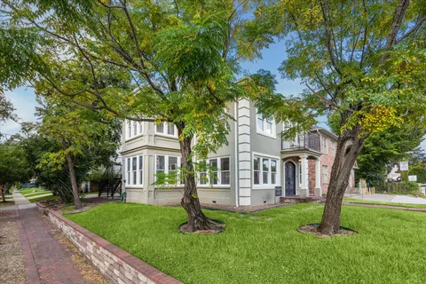a house that has a tree in front of it