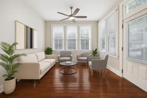 a living room with furniture and a large window