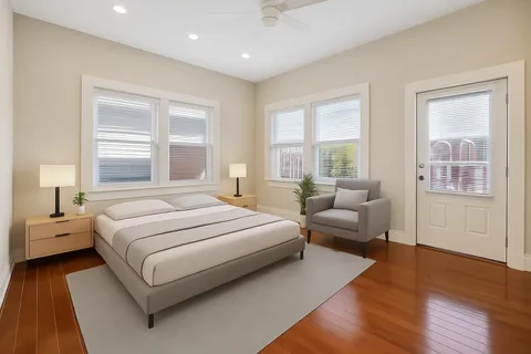 a bedroom with a bed lamp and a window