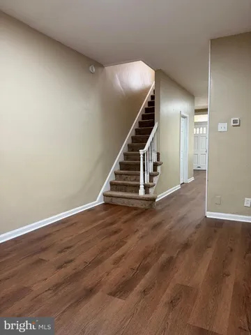 a view of an entryway with wooden floor