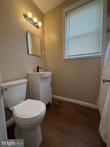 a white toilet sitting next to a bathroom sink