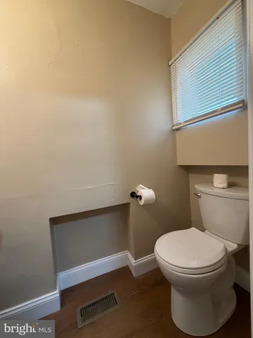 a white toilet sitting next to a bathroom sink