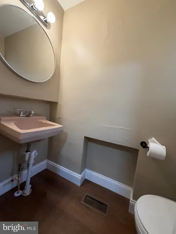 a bathroom with a sink a toilet and mirror