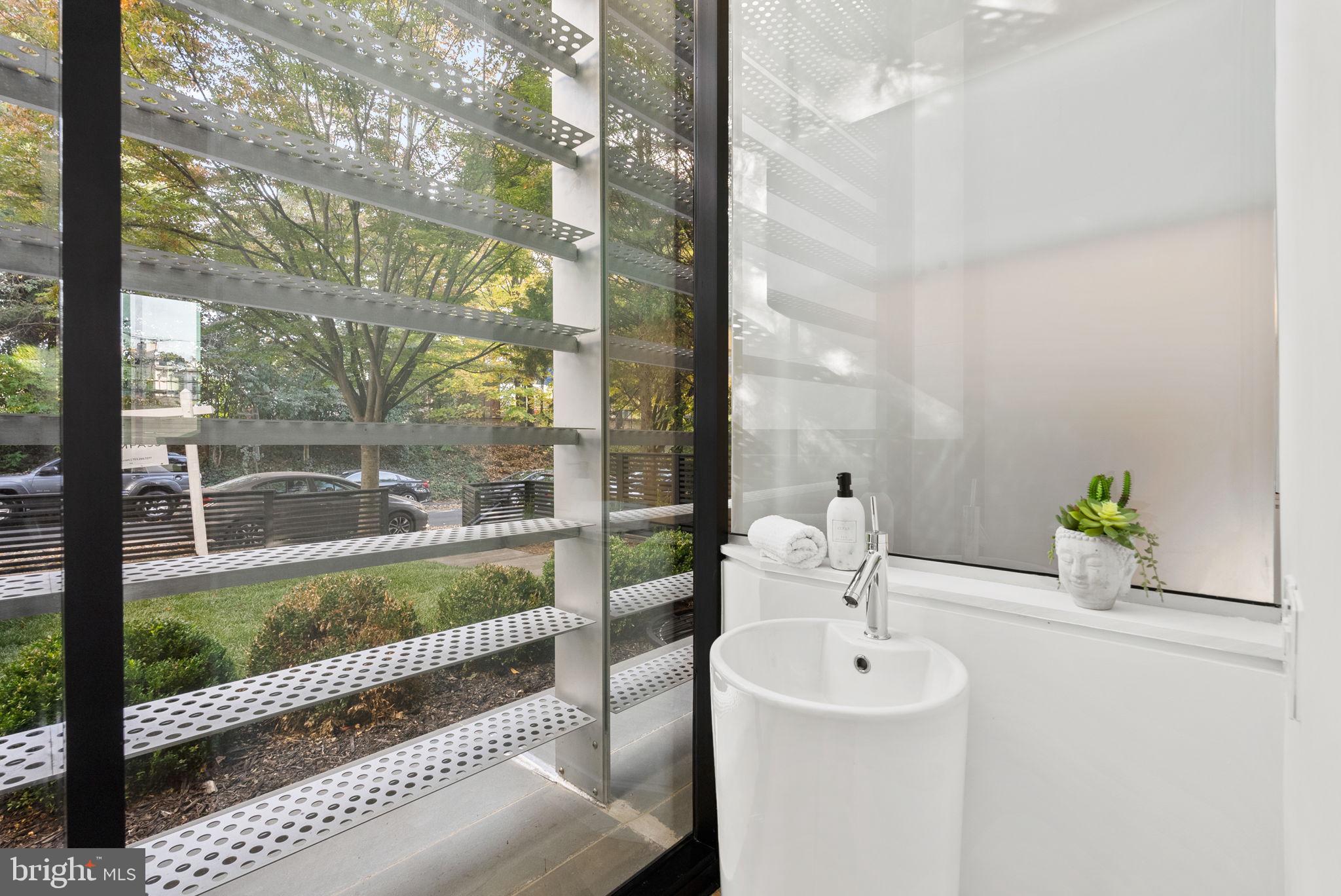 3623 R Street Northwest Washington, DC 20007 - Photo 41 of 87 a bathroom with a sink a mirror and next to a window
