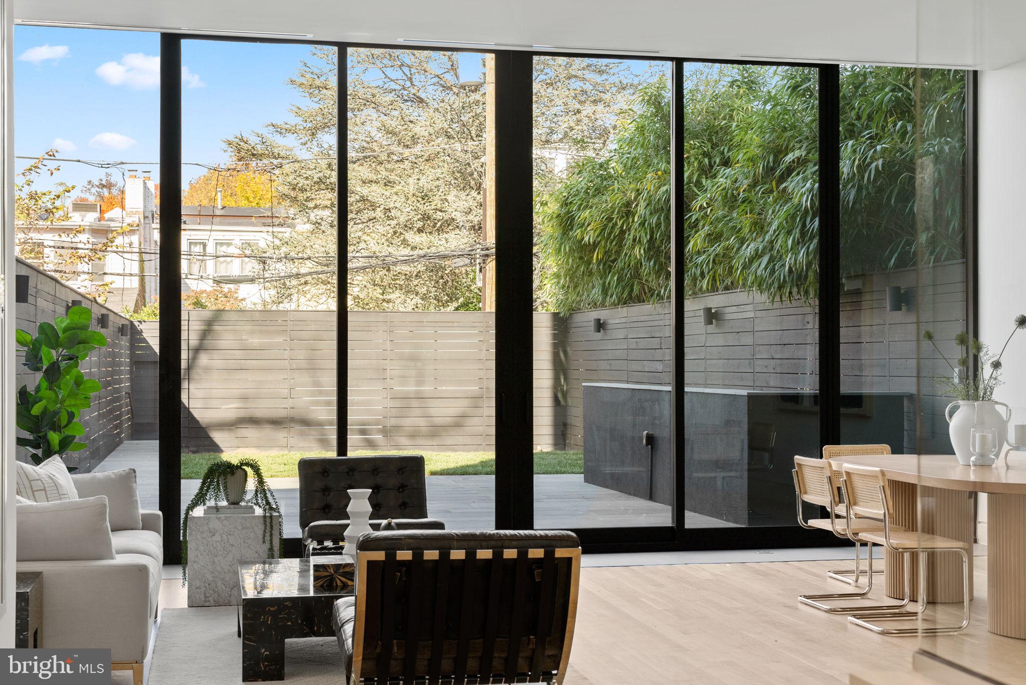 3623 R Street Northwest Washington, DC 20007 - Photo 43 of 87 a living room with patio furniture and a floor to ceiling window