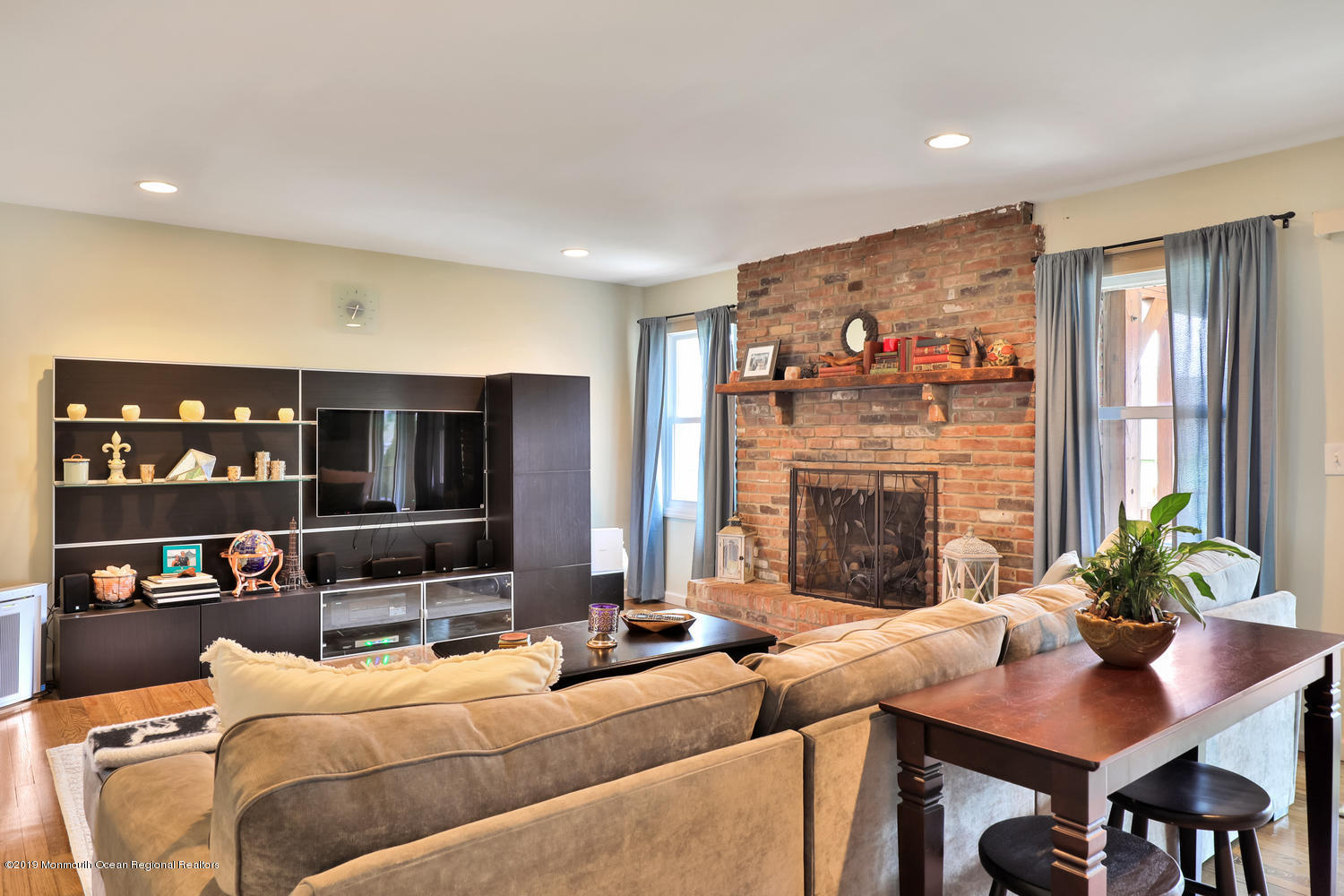 186 Binnacle Road Brick, NJ 08723 - Photo 4 of 25 a living room with furniture a fireplace and a flat screen tv