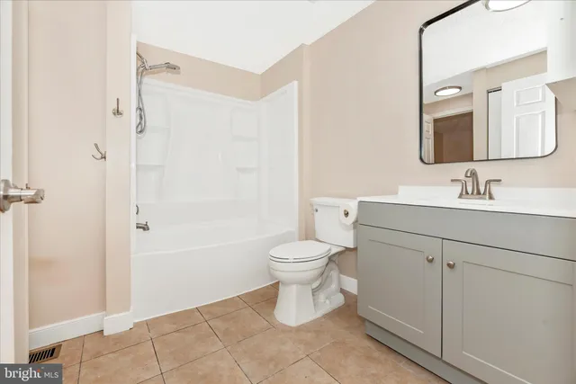 a bathroom with a toilet sink and a mirror