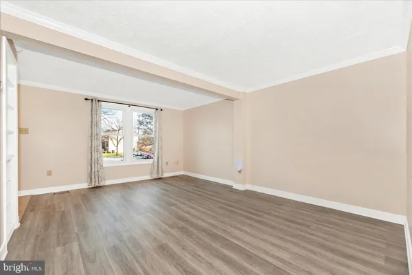 a view of an empty room and wooden floor