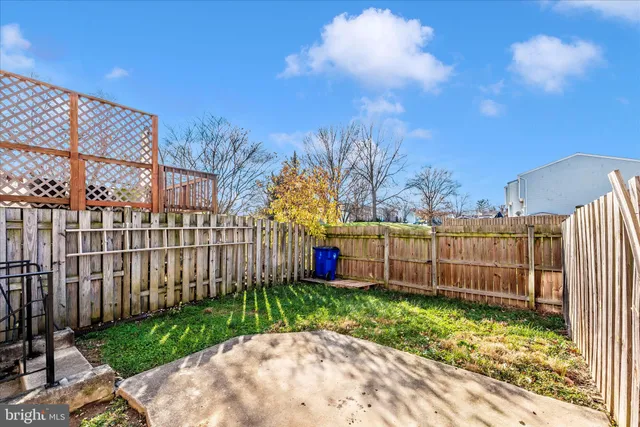 a view of a backyard with wooden fence