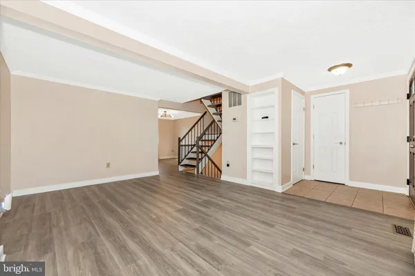 a view of an empty room with wooden floor