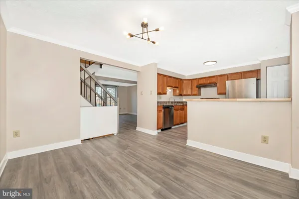 a view of a kitchen with a sink cabinets and wooden floor