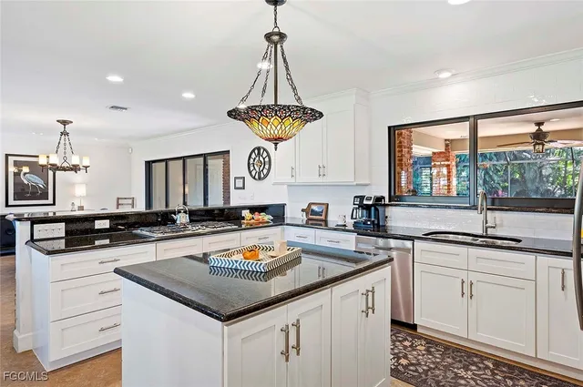 a kitchen with a sink stove and cabinets