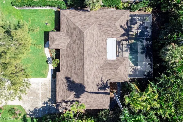 an aerial view of a house with a yard