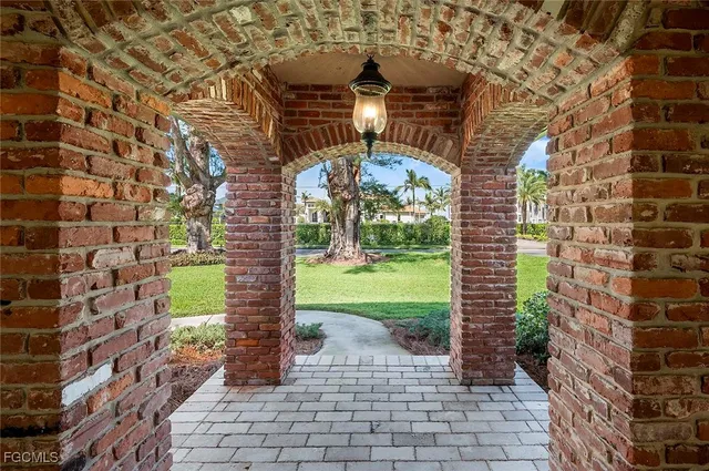 a pathway of a building next to a yard